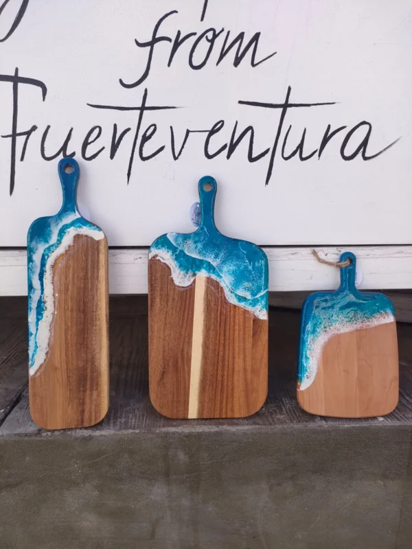 Tres tablas de madera con el borde de resina azul y espuma