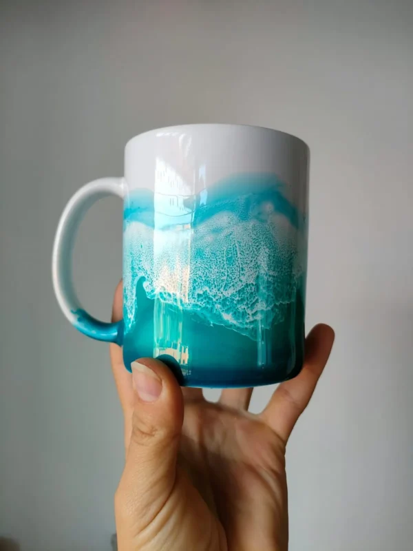 Taza blanca decorada con un paisaje marino en resina